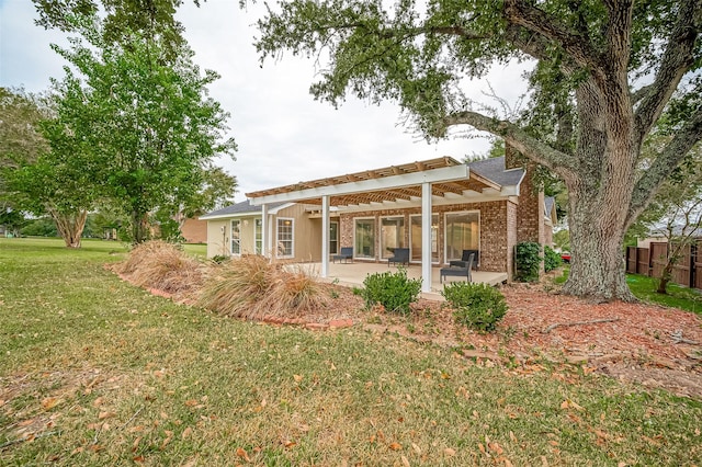 rear view of property with a lawn and a patio area