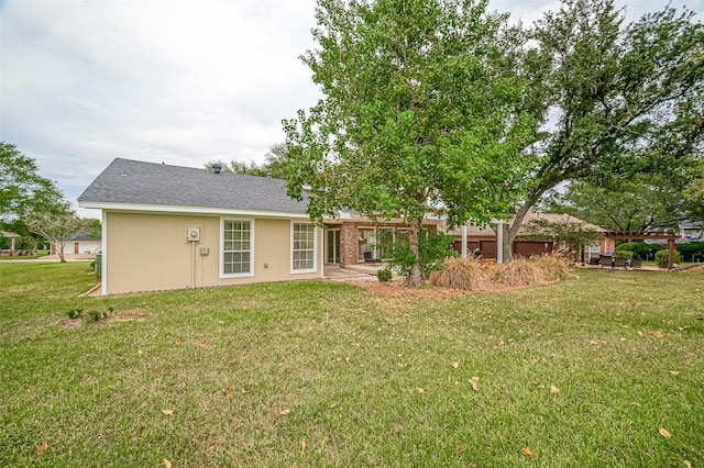 rear view of house featuring a pergola and a yard