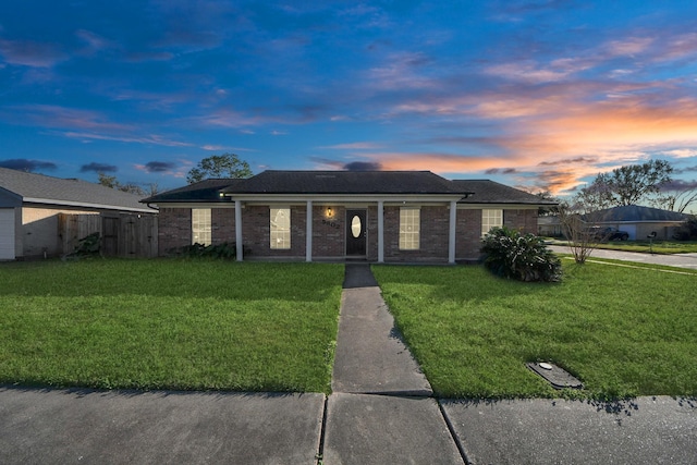 ranch-style home with a lawn