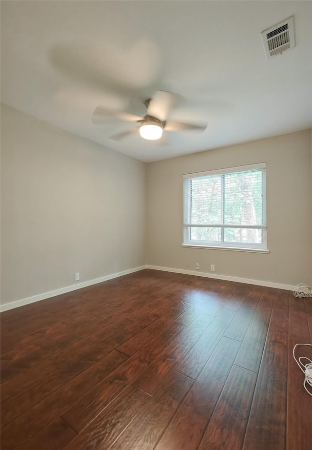 spare room featuring ceiling fan and dark hardwood / wood-style flooring