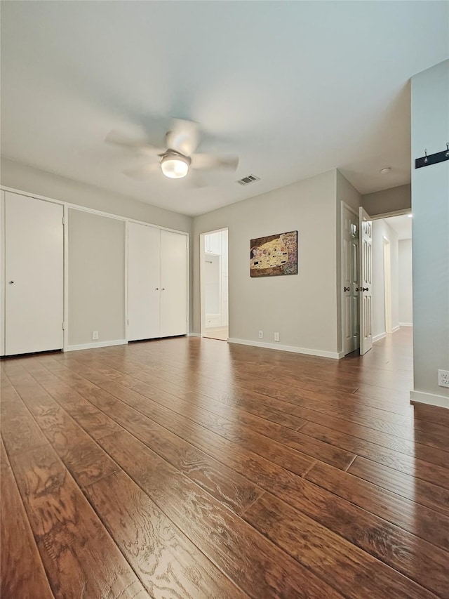 empty room with hardwood / wood-style flooring and ceiling fan