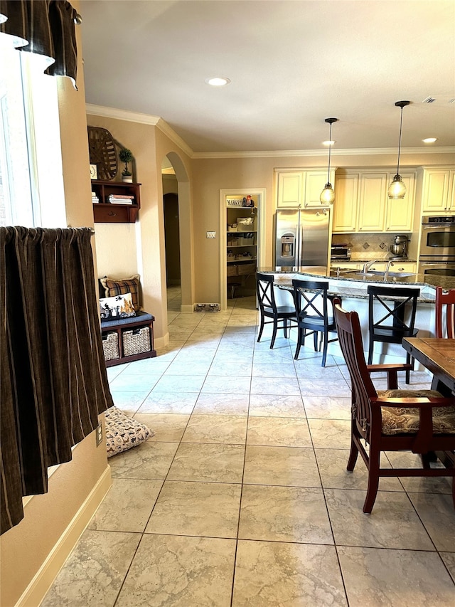 dining room featuring light tile patterned floors and ornamental molding