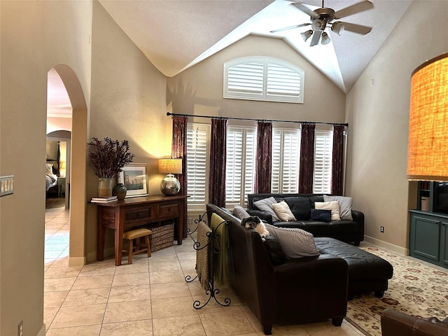 living room featuring ceiling fan and vaulted ceiling