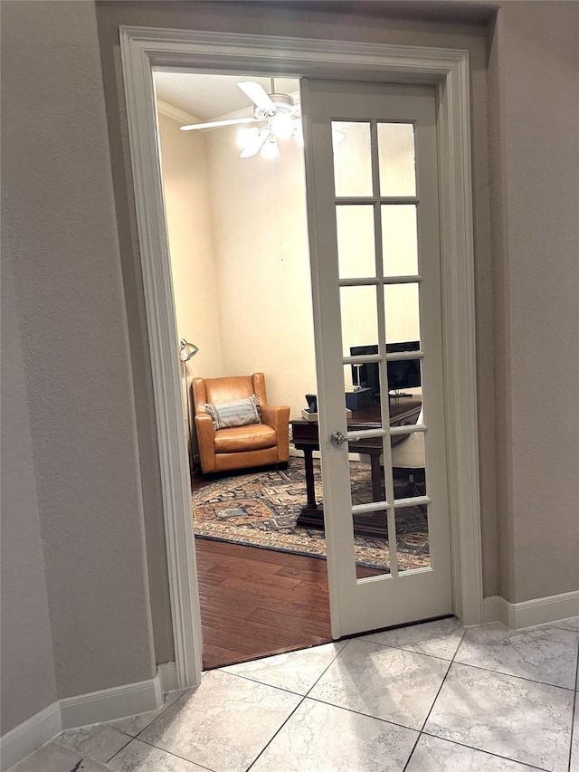 doorway to outside featuring light tile patterned floors, ceiling fan, and crown molding