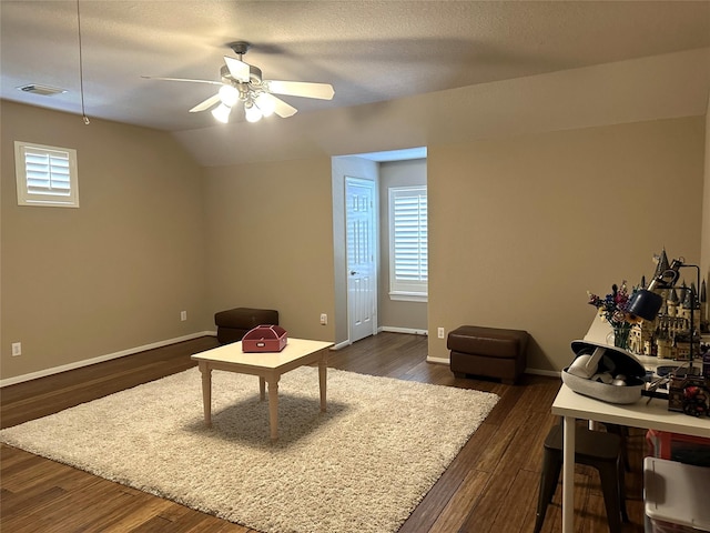 living room featuring ceiling fan, dark hardwood / wood-style flooring, lofted ceiling, and a wealth of natural light