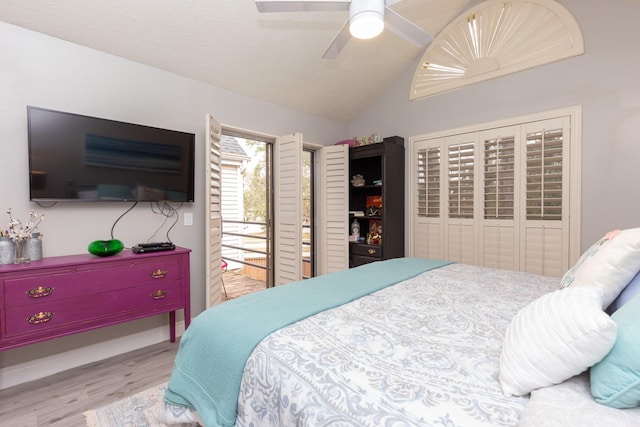 bedroom featuring access to outside, ceiling fan, light hardwood / wood-style floors, and lofted ceiling