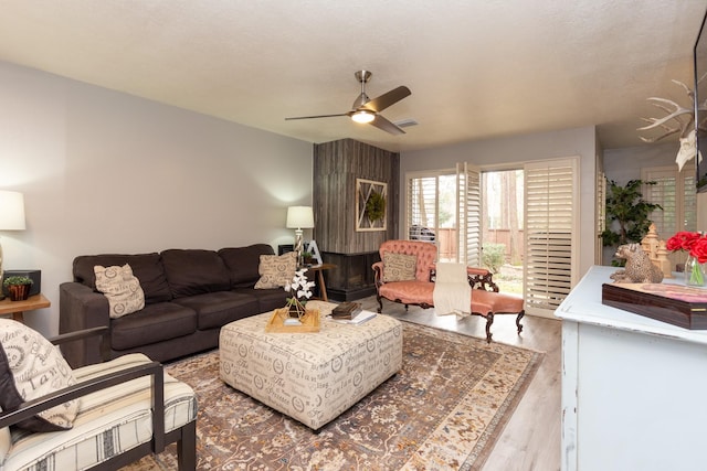 living room featuring light wood-type flooring and ceiling fan