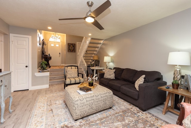 living room with ceiling fan and light hardwood / wood-style floors