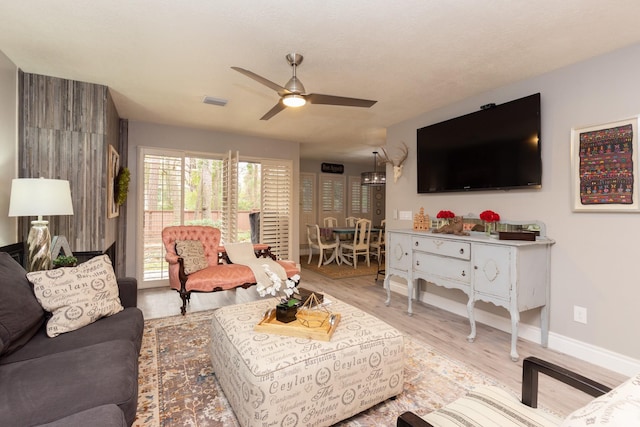 living room featuring ceiling fan and light wood-type flooring