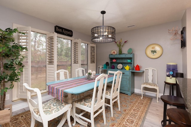 dining room featuring a chandelier and light hardwood / wood-style flooring