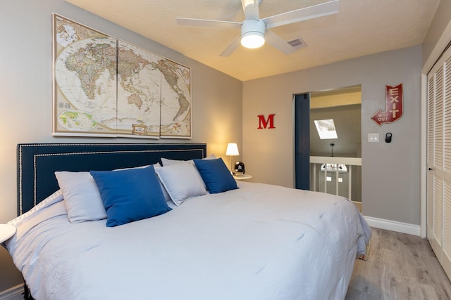 bedroom featuring ceiling fan, a closet, and wood-type flooring