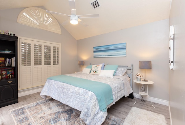 bedroom featuring hardwood / wood-style floors, ceiling fan, and vaulted ceiling