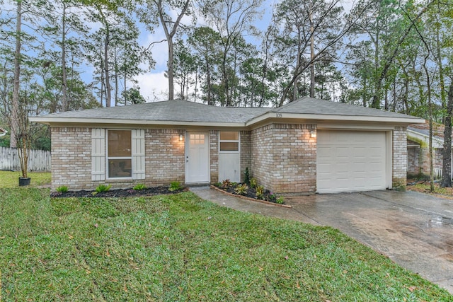 single story home featuring a garage and a front lawn