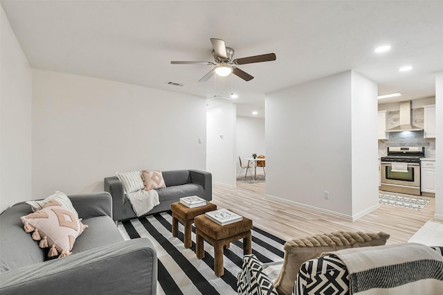 living room featuring light wood-type flooring and ceiling fan