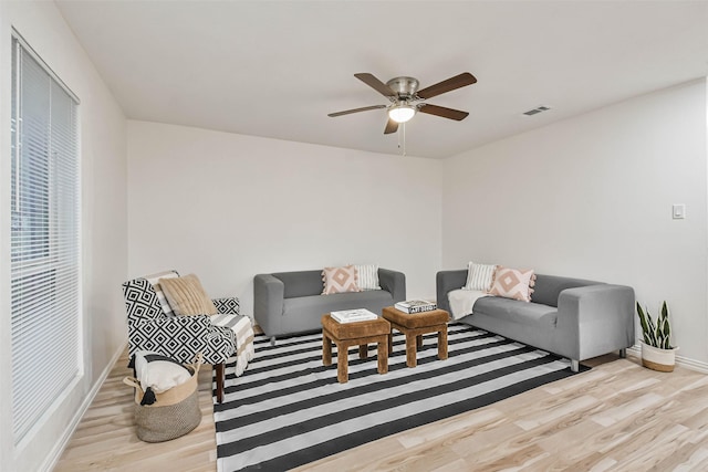 living room with ceiling fan and light wood-type flooring