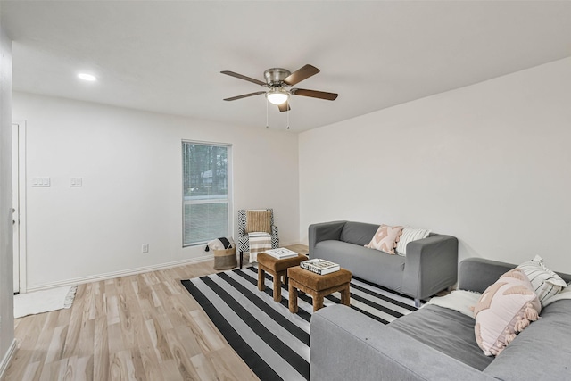 living room featuring ceiling fan and light hardwood / wood-style floors