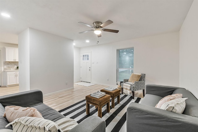 living room with ceiling fan and light hardwood / wood-style floors