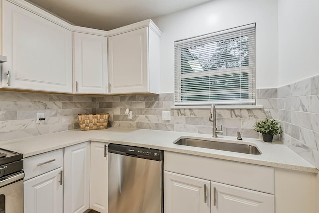 kitchen featuring backsplash, sink, white cabinetry, and stainless steel appliances