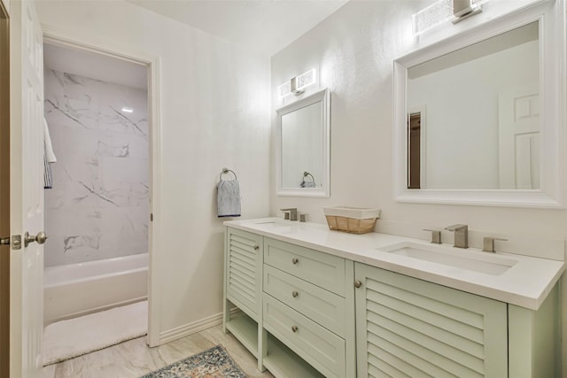 bathroom with vanity and tiled shower / bath