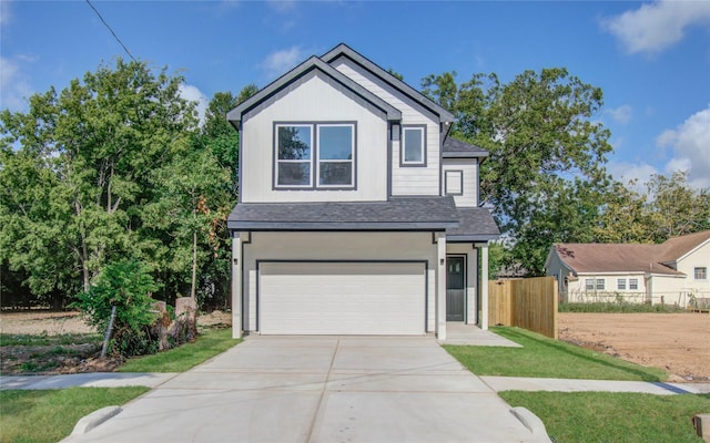 front of property with a garage and a front lawn