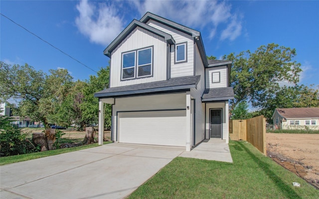 view of front facade featuring a garage and a front yard