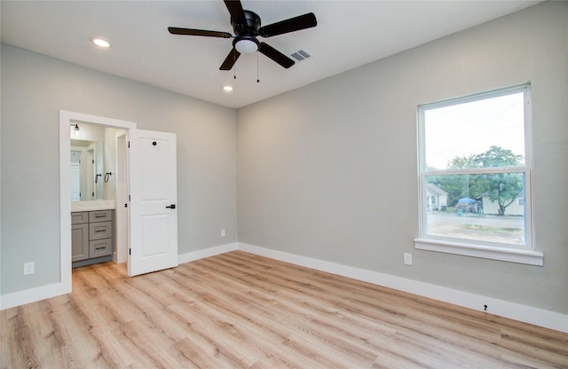 unfurnished bedroom with ensuite bathroom, light hardwood / wood-style flooring, and ceiling fan