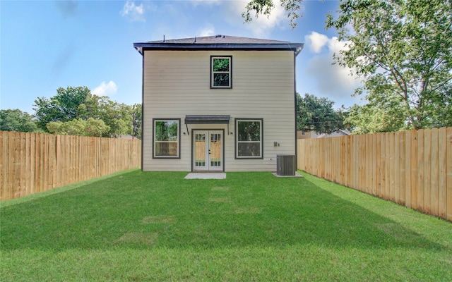 rear view of property featuring french doors and a lawn