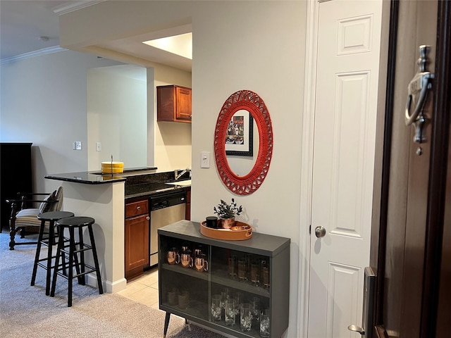 interior space with dishwasher, ornamental molding, and light carpet