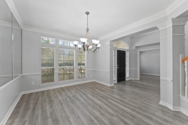 unfurnished dining area with hardwood / wood-style floors, an inviting chandelier, and ornamental molding