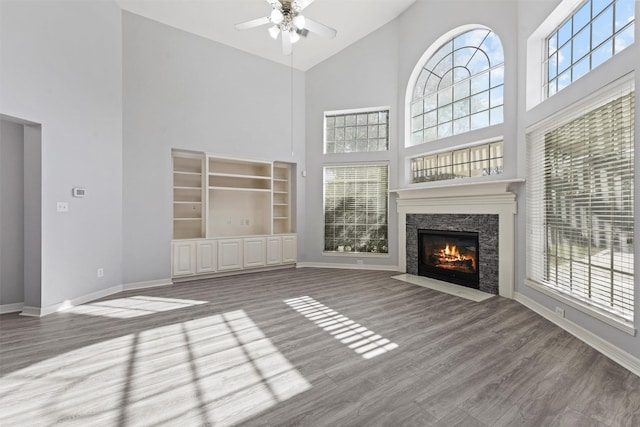 unfurnished living room with a healthy amount of sunlight and a high ceiling