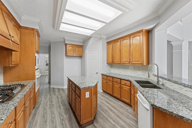 kitchen featuring light stone counters, sink, white appliances, and light hardwood / wood-style flooring