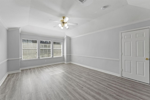 unfurnished room featuring ceiling fan, hardwood / wood-style floors, lofted ceiling, and ornamental molding