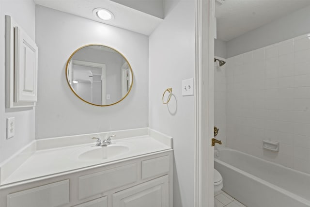 full bathroom featuring vanity, tile patterned flooring, tiled shower / bath combo, toilet, and a textured ceiling