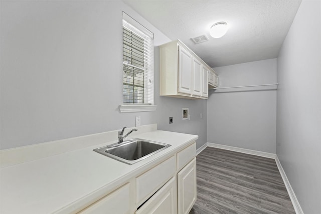 laundry room featuring sink, cabinets, electric dryer hookup, dark hardwood / wood-style flooring, and hookup for a washing machine