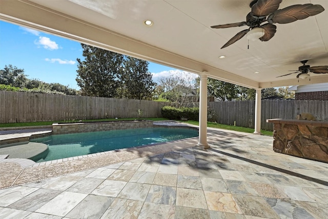 view of swimming pool with ceiling fan and a patio