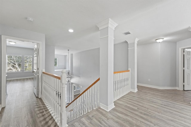 hallway with light hardwood / wood-style floors