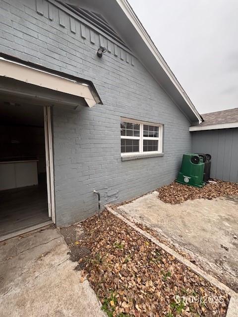 view of side of home featuring cooling unit