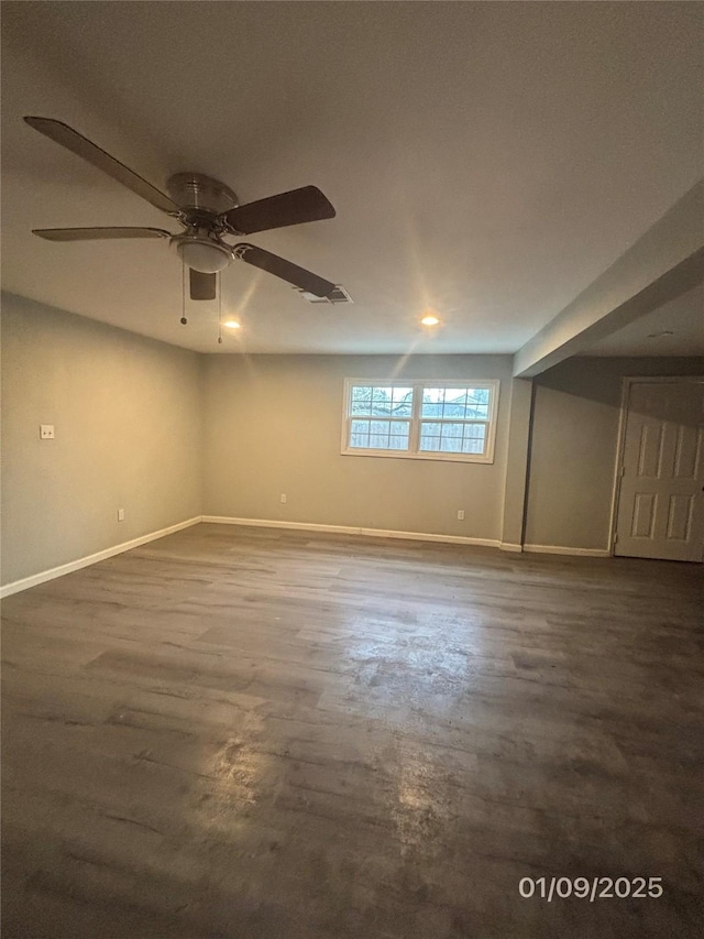 basement featuring ceiling fan and dark wood-type flooring