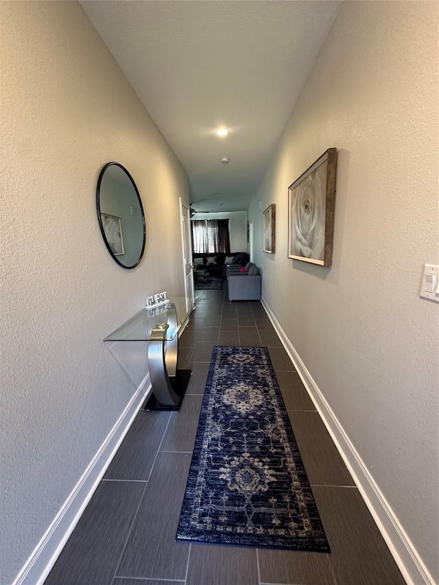 hallway with dark tile patterned floors