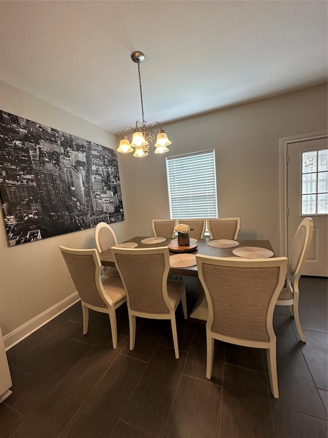 dining area featuring dark wood-type flooring and a notable chandelier