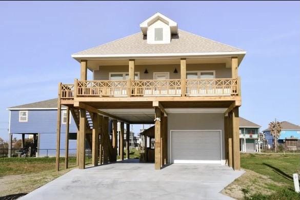 coastal inspired home with a carport and a garage