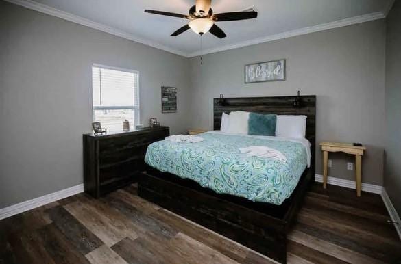 bedroom featuring ceiling fan, ornamental molding, and dark wood-type flooring