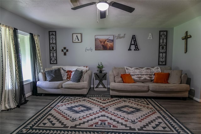 living room with ceiling fan, wood-type flooring, and a textured ceiling