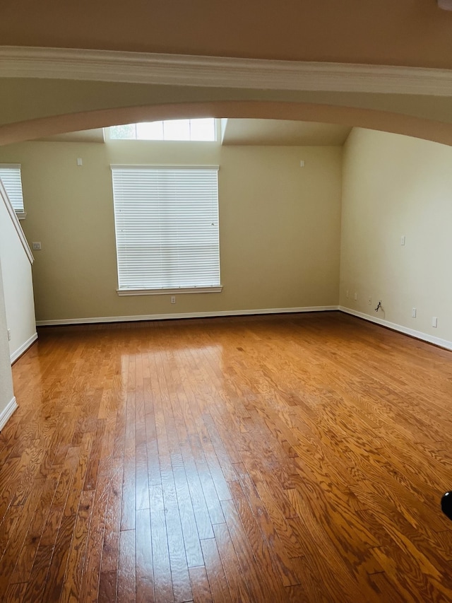 empty room featuring light hardwood / wood-style floors and ornamental molding