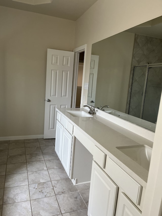 bathroom with tile patterned floors, vanity, and a shower with shower door