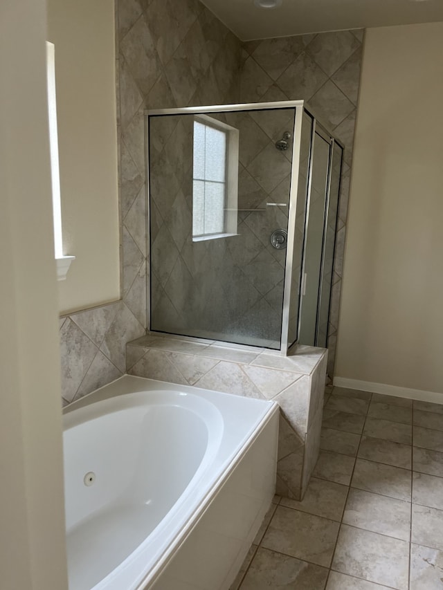 bathroom with tile patterned flooring and independent shower and bath