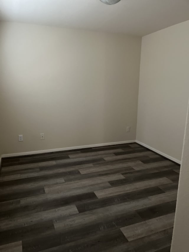 spare room with dark hardwood / wood-style flooring