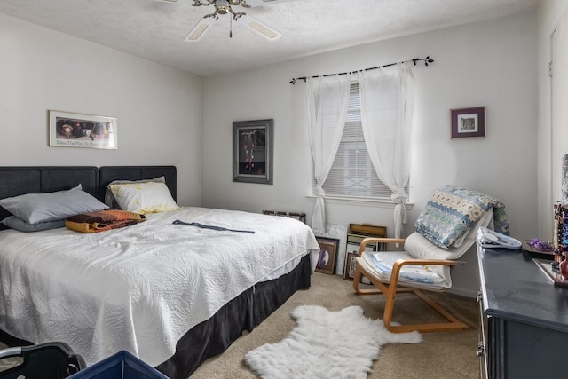 carpeted bedroom featuring a textured ceiling and ceiling fan