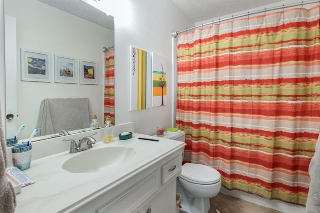 bathroom featuring vanity, curtained shower, and toilet