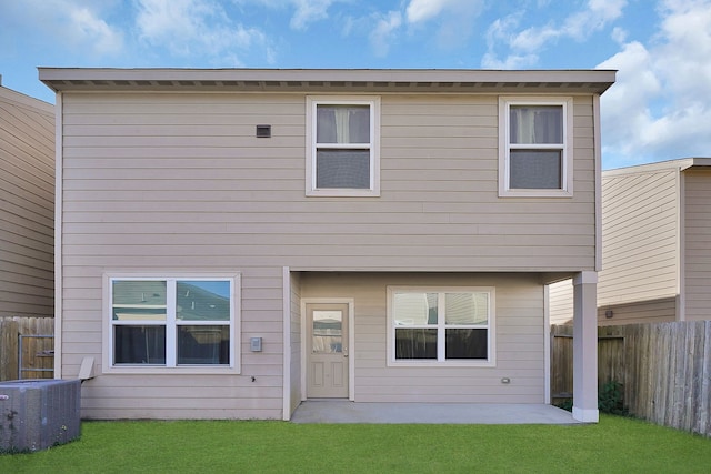 rear view of house with a yard, a patio, and central air condition unit